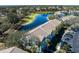 Aerial view of townhomes, showcasing a serene lake and community parking at 4658 Sabal Key Dr, Bradenton, FL 34203
