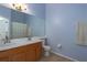 Bathroom featuring double sinks, wood cabinets, and a large mirror at 4658 Sabal Key Dr, Bradenton, FL 34203