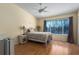 Cozy bedroom featuring laminate floors, a ceiling fan, and a large window for natural light at 4658 Sabal Key Dr, Bradenton, FL 34203
