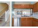 Modern kitchen with stainless steel appliances, wood cabinets, and open view to the living area at 4658 Sabal Key Dr, Bradenton, FL 34203