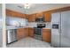 Efficient kitchen with stainless steel appliances, oak cabinetry, and practical design elements at 4658 Sabal Key Dr, Bradenton, FL 34203