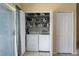 Convenient laundry area with washer, dryer, storage shelves, and adjacent closet at 4658 Sabal Key Dr, Bradenton, FL 34203
