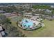Community pool featuring a spacious deck, mature palms, and recreation amenities at 4658 Sabal Key Dr, Bradenton, FL 34203