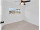 Bedroom featuring a ceiling fan and window at 4822 Linwood St, Sarasota, FL 34232