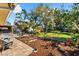 Spacious backyard with a stone patio, lush lawn, mature trees and lovely landscaping, great for entertaining at 503 Park Dr, Bradenton, FL 34209