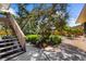 A brick backyard features lush foliage and mature trees, creating a relaxing outdoor oasis at 503 Park Dr, Bradenton, FL 34209