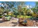 Lush backyard featuring a stone patio, a well-maintained lawn, and beautiful landscaping, perfect for outdoor enjoyment at 503 Park Dr, Bradenton, FL 34209