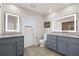 Well lit bathroom features double vanity, tile floor, and exit door at 503 Park Dr, Bradenton, FL 34209