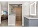 Bathroom with grey vanity, walk-in shower, and tile floor at 503 Park Dr, Bradenton, FL 34209