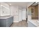 Spacious bathroom with double vanity, illuminated mirrors, tile floors, and walk-in shower at 503 Park Dr, Bradenton, FL 34209