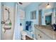 Bright bathroom with white tile shower, beadboard detail and blue accents at 503 Park Dr, Bradenton, FL 34209