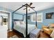 Charming bedroom with hardwood floors, a four-poster bed, and natural light at 503 Park Dr, Bradenton, FL 34209