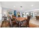 Bright dining room featuring a large wooden table, wicker chairs, and colorful rug at 503 Park Dr, Bradenton, FL 34209