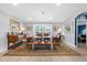 Bright dining room featuring a large wooden table, wicker chairs, neutral walls, and a colorful rug at 503 Park Dr, Bradenton, FL 34209