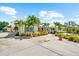 Charming home with lush landscaping, palm trees, turquoise shutters, and a spacious driveway at 503 Park Dr, Bradenton, FL 34209