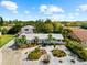 Beautiful home with metal roof, well-manicured landscaping, circular driveway, and mature palm trees at 503 Park Dr, Bradenton, FL 34209