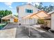 Exterior of a two-story home with a white facade, turquoise shutters, a carport, and a shed in the backyard at 503 Park Dr, Bradenton, FL 34209