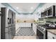 Well-lit kitchen with stainless steel appliances, white cabinets, and a blue accent stripe at 503 Park Dr, Bradenton, FL 34209