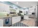 Functional kitchen featuring stainless steel appliances, white cabinets, and backyard views at 503 Park Dr, Bradenton, FL 34209