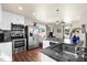 A modern kitchen is equipped with stainless steel appliances, granite countertops, and white cabinetry at 503 Park Dr, Bradenton, FL 34209