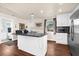 Modern kitchen featuring granite countertops, stainless steel appliances, and an island with bar stools for casual dining at 503 Park Dr, Bradenton, FL 34209