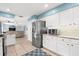 Efficient kitchen with stainless steel appliances, white cabinets, and an open view to the living room at 503 Park Dr, Bradenton, FL 34209