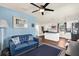 The open-concept living area features bright blue walls, a ceiling fan, and easy access to the kitchen at 503 Park Dr, Bradenton, FL 34209
