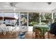 Enclosed porch area featuring stylish outdoor furniture with views of the lush backyard at 503 Park Dr, Bradenton, FL 34209
