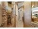 Luxurious walk-in shower featuring a unique shower system and stone tile walls at 5141 Lansdowne Way, Palmetto, FL 34221