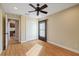 Bedroom with hardwood floors, closet, ceiling fan, and neutral paint; view of adjacent office at 5141 Lansdowne Way, Palmetto, FL 34221