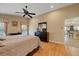 Comfortable bedroom featuring hardwood floors, neutral walls and a door leading to the kitchen at 5141 Lansdowne Way, Palmetto, FL 34221