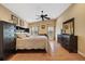 Spacious bedroom with a ceiling fan, wooden floors and neutral-colored walls with decorative art pieces at 5141 Lansdowne Way, Palmetto, FL 34221