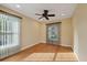 Bright bedroom with wood floors, a ceiling fan, and windows with stylish window treatments at 5141 Lansdowne Way, Palmetto, FL 34221