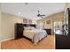 Spacious main bedroom featuring wood floors, tray ceiling with fan, and neutral colored walls at 5141 Lansdowne Way, Palmetto, FL 34221