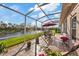 Relaxing screened patio features outdoor seating with a view of the scenic backyard at 5141 Lansdowne Way, Palmetto, FL 34221