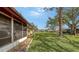Spacious backyard featuring a well-maintained lawn and mature trees for shade at 515 Rousseau Dr, Nokomis, FL 34275