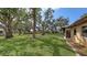 Spacious backyard with mature trees providing ample shade and privacy at 515 Rousseau Dr, Nokomis, FL 34275