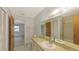 Bathroom featuring a tiled floor, a wide mirror, and a combination shower and tub at 515 Rousseau Dr, Nokomis, FL 34275