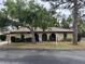 Charming single-story home featuring a red tile roof and mature trees in a well-manicured yard at 515 Rousseau Dr, Nokomis, FL 34275