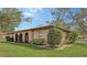 Beautiful one-story home featuring a low-pitched tile roof, stucco walls, arched doorway, and lush landscaping at 515 Rousseau Dr, Nokomis, FL 34275