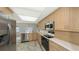 Kitchen featuring stainless steel appliances, ample lighting, and lots of cabinet space at 515 Rousseau Dr, Nokomis, FL 34275