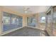 Enclosed patio with sliding doors, ceiling fan, and multiple windows offering natural light at 515 Rousseau Dr, Nokomis, FL 34275