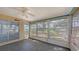 Enclosed patio with sliding glass door, ceiling fan, and multiple windows providing natural light at 515 Rousseau Dr, Nokomis, FL 34275