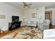 Bright living room with light-colored furniture, and a leafy area rug at 5310 Hyland Hills Ave # 2114, Sarasota, FL 34241