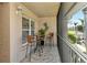 Relaxing screened balcony with bistro table and chairs, plus a decorative lizard at 5320 Hyland Hills Ave # 2222, Sarasota, FL 34241