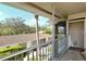 View from screened balcony with tile floor, steel railing and palm tree in distance at 5320 Hyland Hills Ave # 2222, Sarasota, FL 34241