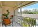 Relaxing screened balcony with bistro table and chairs, plus a decorative lizard at 5320 Hyland Hills Ave # 2222, Sarasota, FL 34241