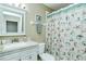 Bathroom featuring vanity, decorative shower curtain, and framed mirror at 5320 Hyland Hills Ave # 2222, Sarasota, FL 34241