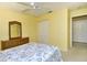 Bedroom with ceiling fan, yellow walls, wicker furniture, and closet at 5320 Hyland Hills Ave # 2222, Sarasota, FL 34241