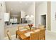 Dining area with wooden table and chairs, adjacent to a modern kitchen with a view of the entryway at 5320 Hyland Hills Ave # 2222, Sarasota, FL 34241